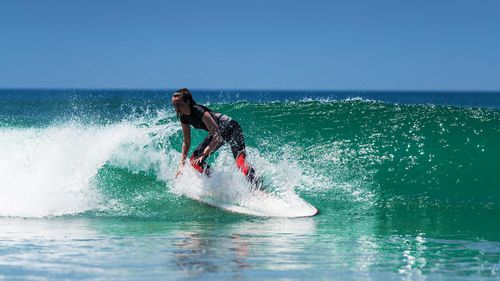 Surfing The Waves Of Varkala