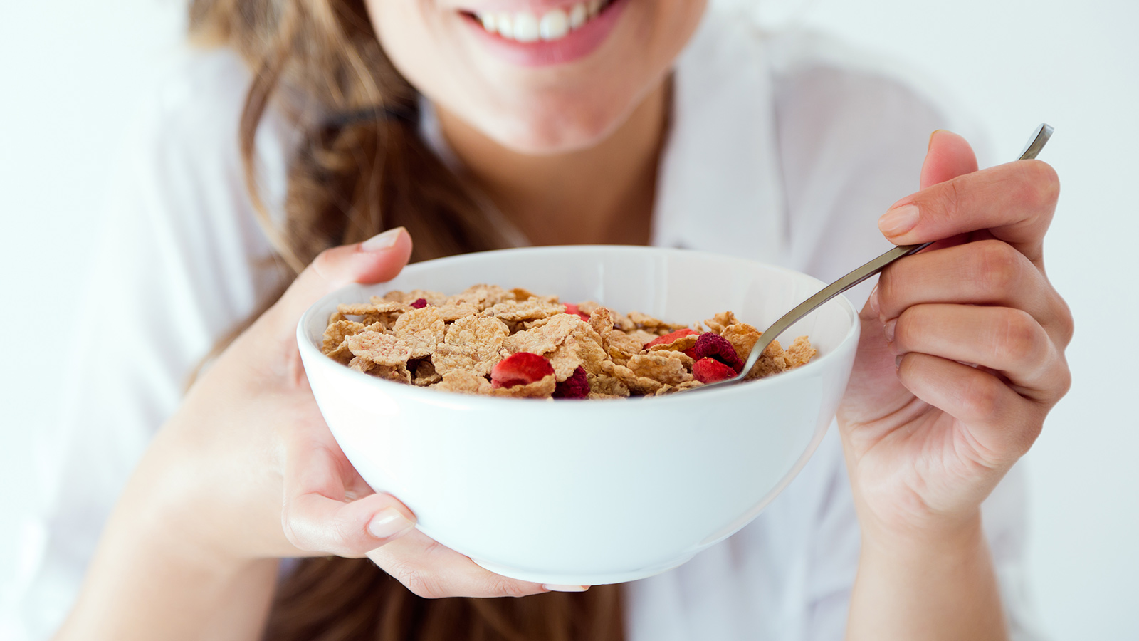 girl eating cereal in a bowl