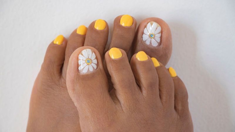 Womans feet with spring summer nail design on pink background. Body  treatment Stock Photo - Alamy